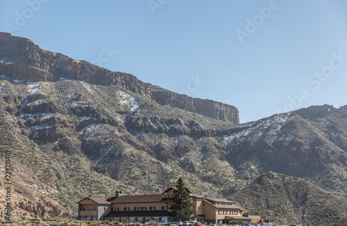 Large building with rest area in the middle of a mountainous area, on a beautiful sunny dayLarge building with rest area in the middle of a mountainous area photo