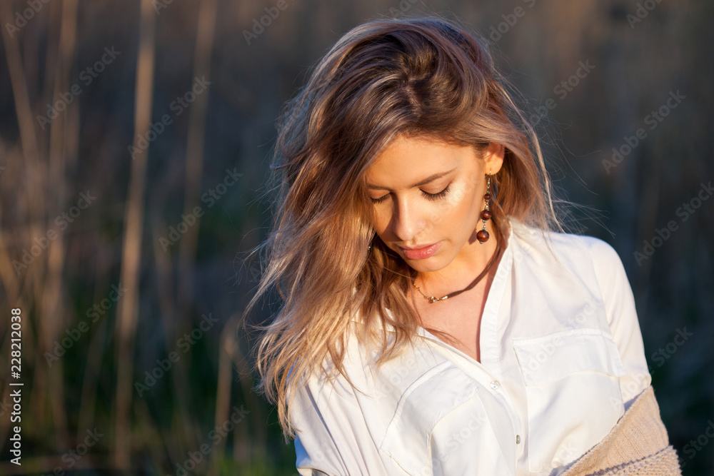 Cute charming girl in summer in the field. Young woman is happy and feels free outdoors Cute charming girl in summer in the field. Young woman is happy and feels free outdoors
