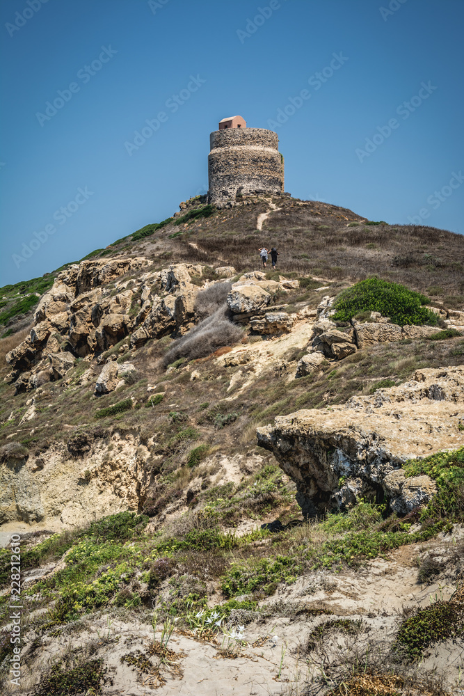Tower of San giovanni of corinthian ruins of Tharros village on a beautiful clear sunny day in Sinis peninsula, Cabras, Oristano, Sardinia, Italy. Tower of San giovanni of corinthian ruins of Tharros village on a beautiful clear sunny day in Sinis peninsula, Cabras, Oristano, Sardinia, Italy.
