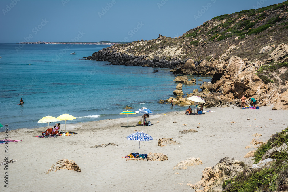 Uncrowded beach scene on a clear sunny day in summer.  Captured in Seu Coast, Oristano province, Sardinia, Italy