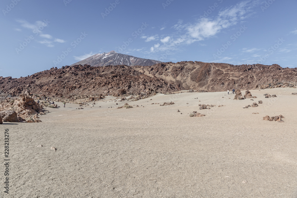 Landscape of sand, lava and the Teide volcano in the background