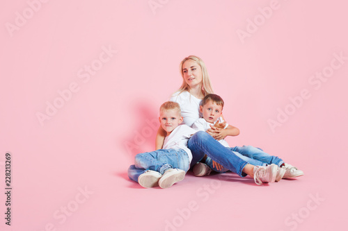 happy mom with two happy sons. Young woman and two baby boys