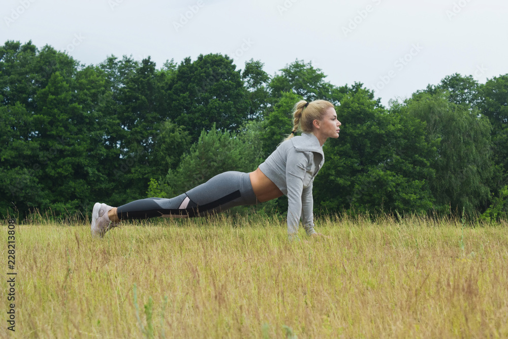 Fit women stretching the muscles of her legs Fit women stretching the muscles of her legs