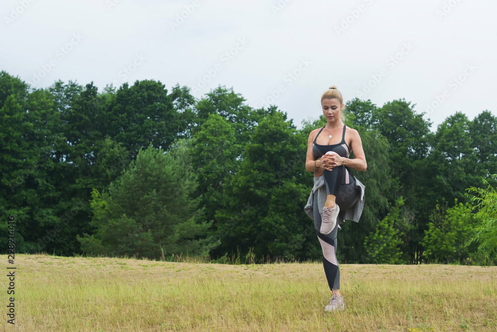 Fit women stretching the muscles of her legs Fit women stretching the muscles of her legs