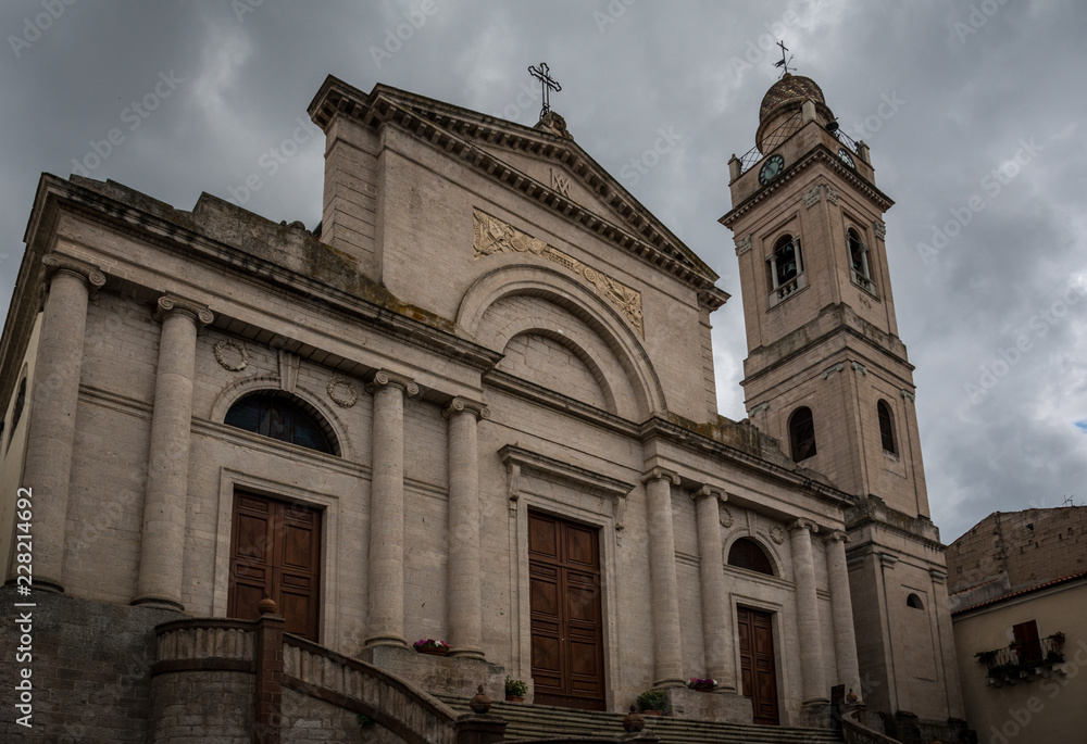 Church exterior of Cattedrale Dell`Immacolata in Ozieri, Sardinia, Italy on a cloudy summer day.