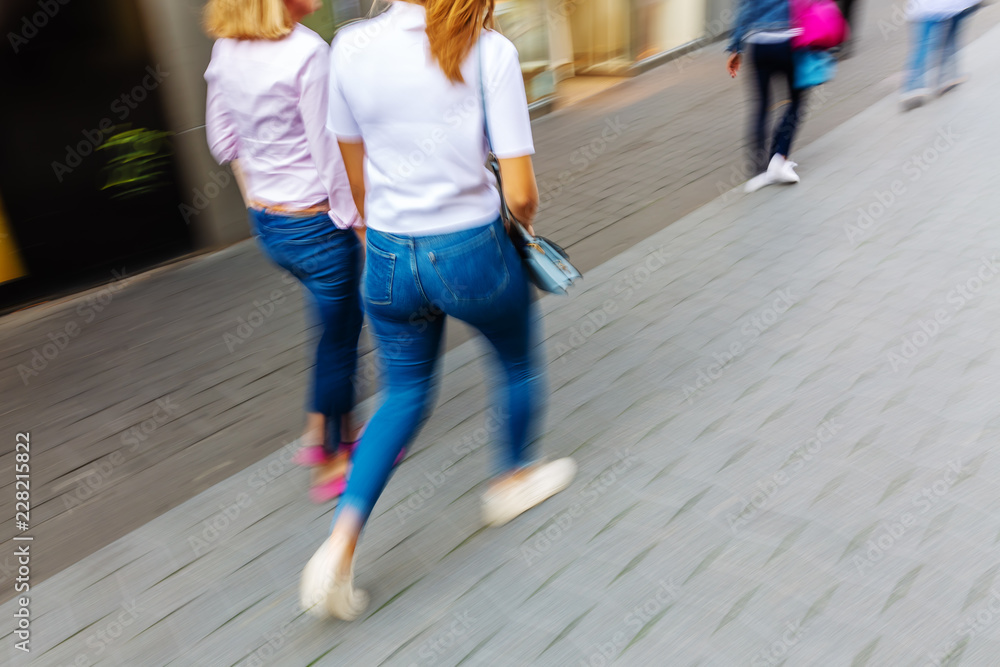 shopping women walking in the pedestrian zone of a city