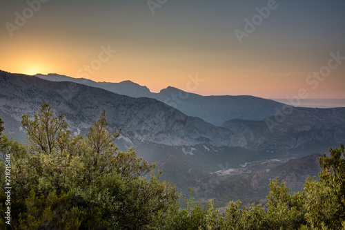 Panoramic Mountain Landscape view during a beautiful sunset, with layered blue mountains, Sardinia, Orosei region.