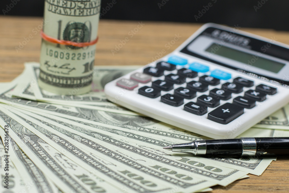 Fototapeta premium Pen,calculator,account book and coins for finance and banking concept