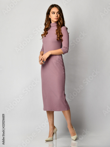 Obraz na płótnie Young beautiful woman posing in new light purple fashion winter dress on high hills full body w salonie