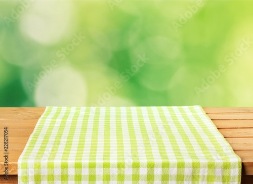Green cloth napkin on wooden background