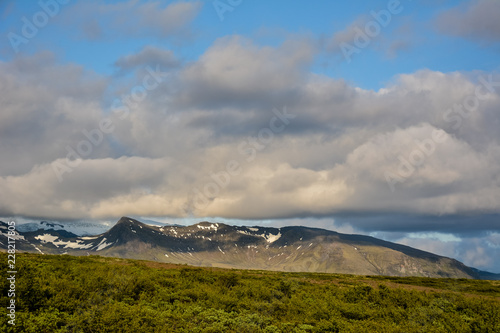 Skaftafell national park mountains and cumulus clouds, Iceland in summer