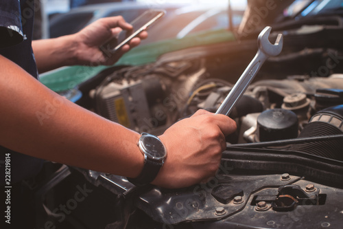 Handyman services holding a screwdriver and Search for information from mobile phones.