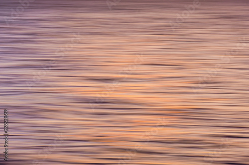 Impressionistic blur of movement of waves at sunset make a great background