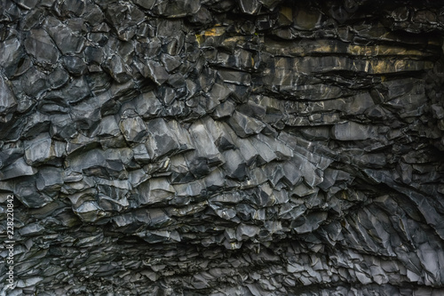 Basalt stone columns close-up on Reynisfjara black beach near  Vik town, Iceland. Texture and background. photo
