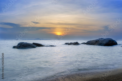 Relaxing seascape with wide horizon of the colorful sky and stones