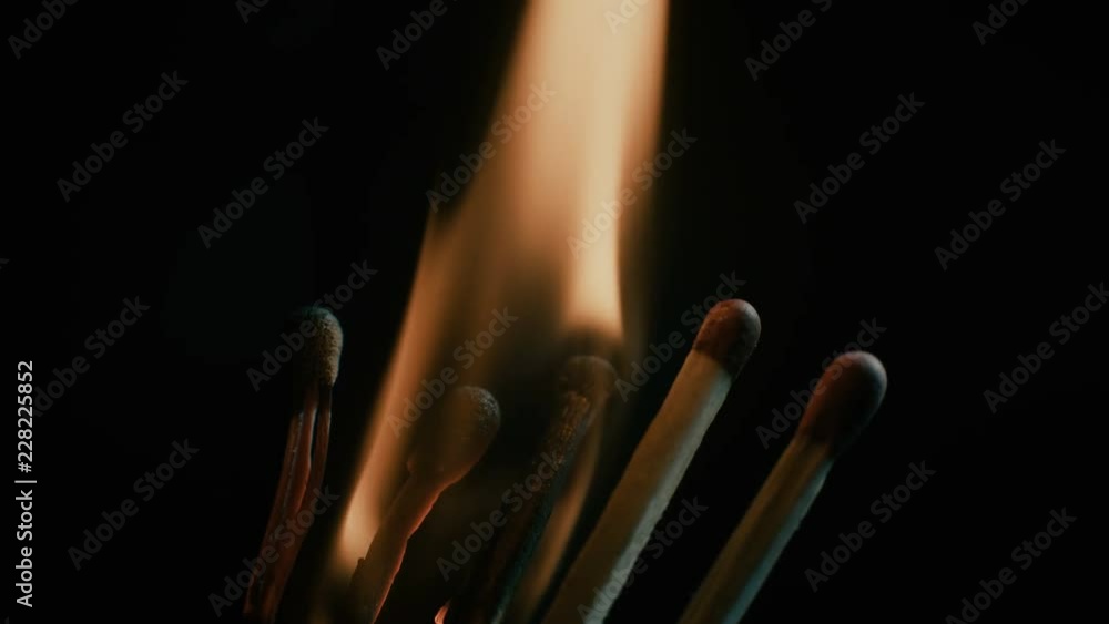 Burning matches close-up over black background.
Chain effect. Burning matches close-up over black background.
Chain effect.