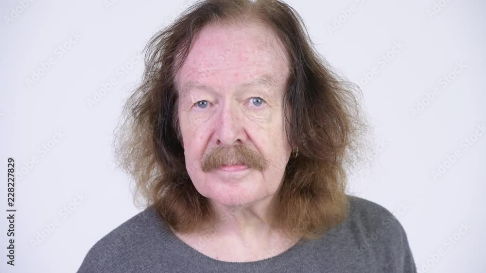Head shot of senior man with mustache against white background Head shot of senior man with mustache against white background