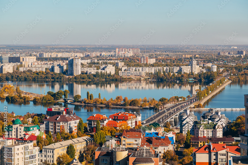 Sunny golden autumn Voronezh. Aerial view from skyscraper roof height to Chernavsky bridge through Voronezh river