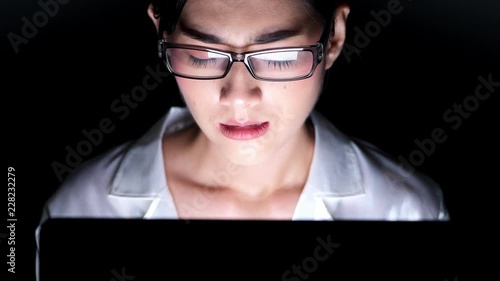 Woman working late at her home office. Close up of beautiful asian woman talking on phone, got complaint from customer, getting very stress, wearing glasses. Modern global connected business concept.