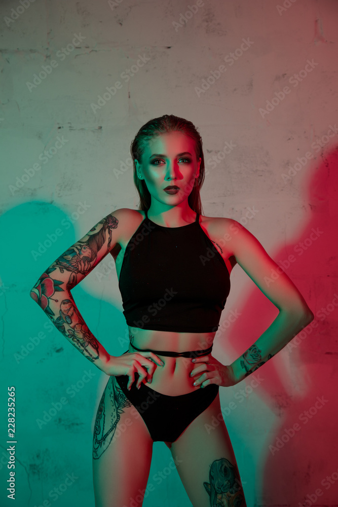 Obraz premium Tattooed girl in black lingerie cropped view