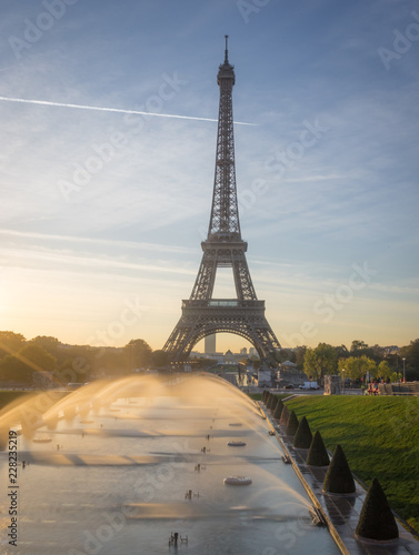 Paris, France - 10 13 2018: View of the Eiffel Tower with water jet from the garden of Trocadero at sunrise