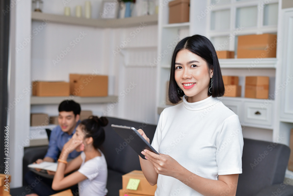 Sme business concept. Young Asian people are packing their packages. Young people are communicating with the phone. Sme business concept. Young Asian people are packing their packages. Young people are communicating with the phone.