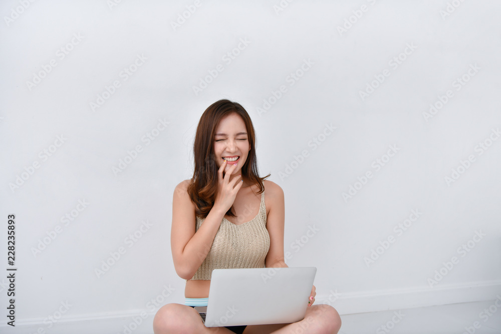 Beautiful girl in casual wear playing computer at home. Beautiful girl in casual wear playing computer at home.