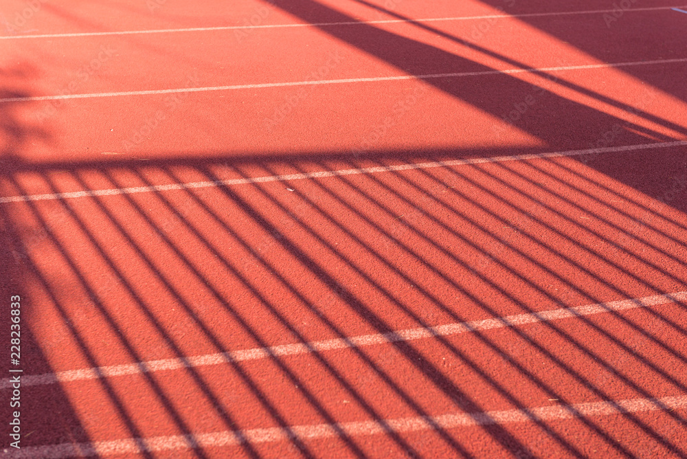 Shadow of palisade on running track