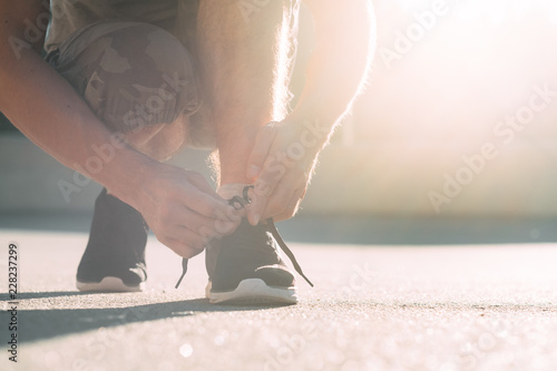 runner tying shoelaces. outdoor sport and athletic lifestyle. healthy and active leisure.