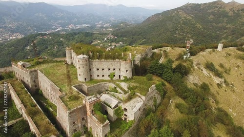 Aerial shot tilting down as camera flies over Forte Sperone in Genoa, Italy