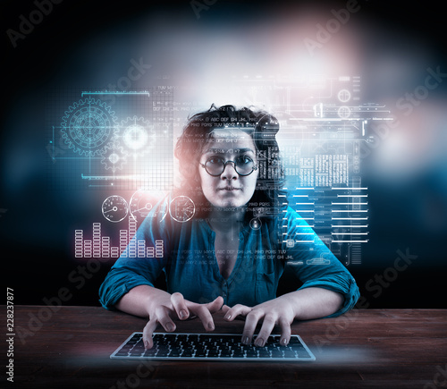 Woman working on laptop with a futuristic infograph