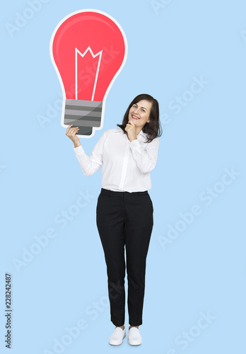 Businesswoman holding a light bulb