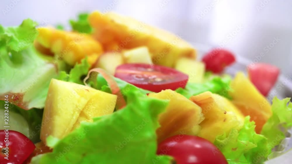 Organic green salad with various kinds of fruits in rotating macro shot - Healthy lifestyle Organic green salad with various kinds of fruits in rotating macro shot - Healthy lifestyle