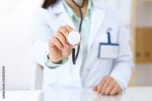 Doctor holds stethoscope head, close-up. Medical help and insurance in health care, best treatment and medicine concept