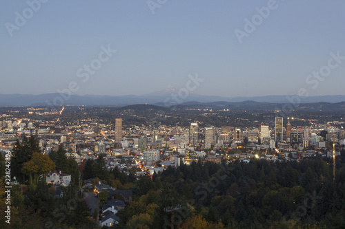 Portland Oregon downtown skyline at dusk with Mt Hood in the distance.