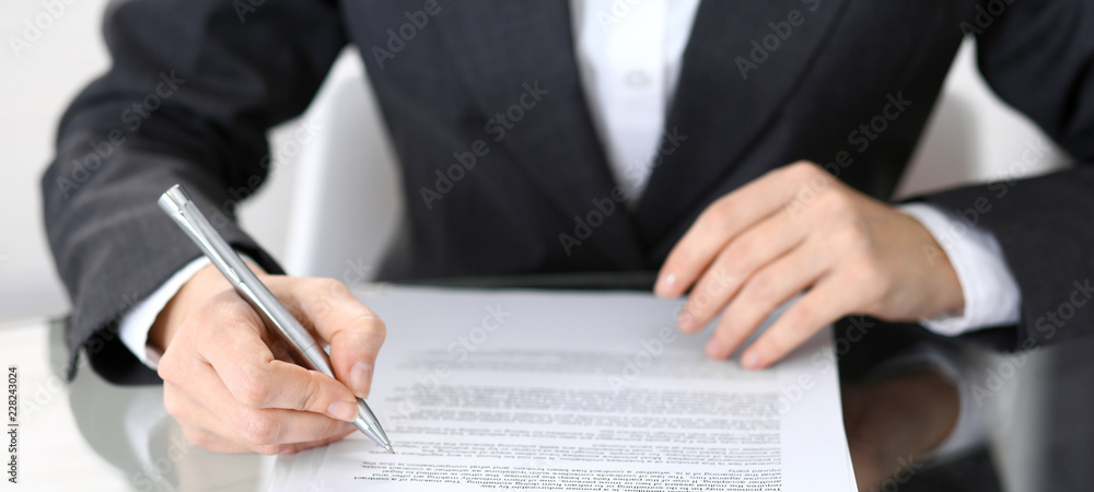 Close-up of female hands with pen over document of contact, business concept Close-up of female hands with pen over document of contact, business concept