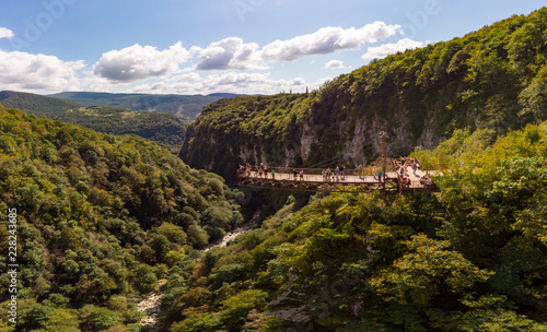 Beautiful panoramic view from the drone to Tourists On Observation Platform on Suspension Bridge Up To 140 Meters Above Precipice Okatse Canyon, Zeda-gordi, Dadiani park Kutaisi, Georgia.