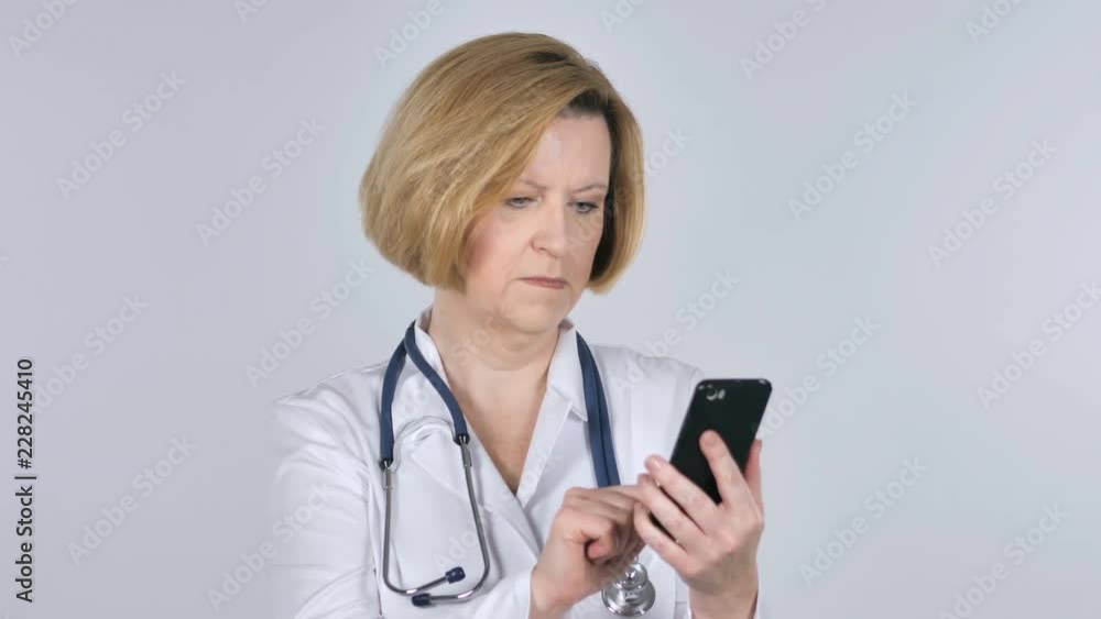 Old Doctor Browsing Smartphone, White Background Old Doctor Browsing Smartphone, White Background