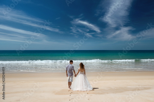 Wedding couple at idyllic sea beach