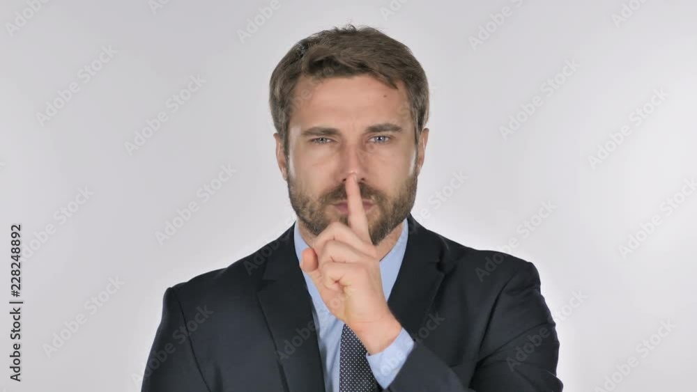 Portrait of Businessman Gesturing Silence, Finger on Lips Portrait of Businessman Gesturing Silence, Finger on Lips