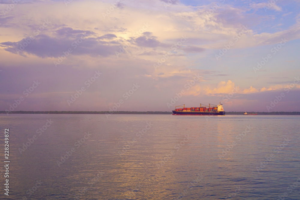 Sea sunset with cargo ship