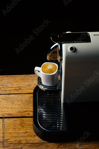 Fresh cup of coffee. Capsule coffee machine