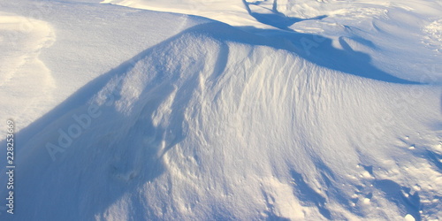 Fotografie Winter, snow - beautiful close-up snowdrifts with landcsape shadows on the north