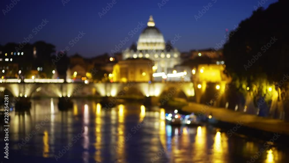 Out of focus camera moving across river near San Pietro Basilica in Vatican City Out of focus camera moving across river near San Pietro Basilica in Vatican City