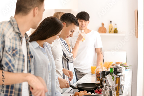 Friends cooking together in...