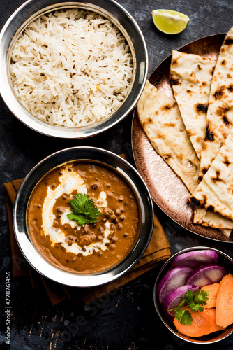 Dal makhani / makhni is a popular dish from India. Made with ingredients like whole black lentil, butter and cream. Served with Naan/roti and rice