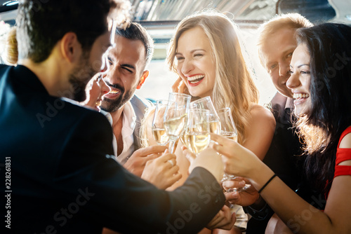 Bild auf Leinwand Birthday party in a limo with glasses of champagne