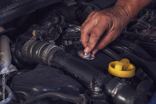 Car service worker diagnoses car breakdown. © Ахтем