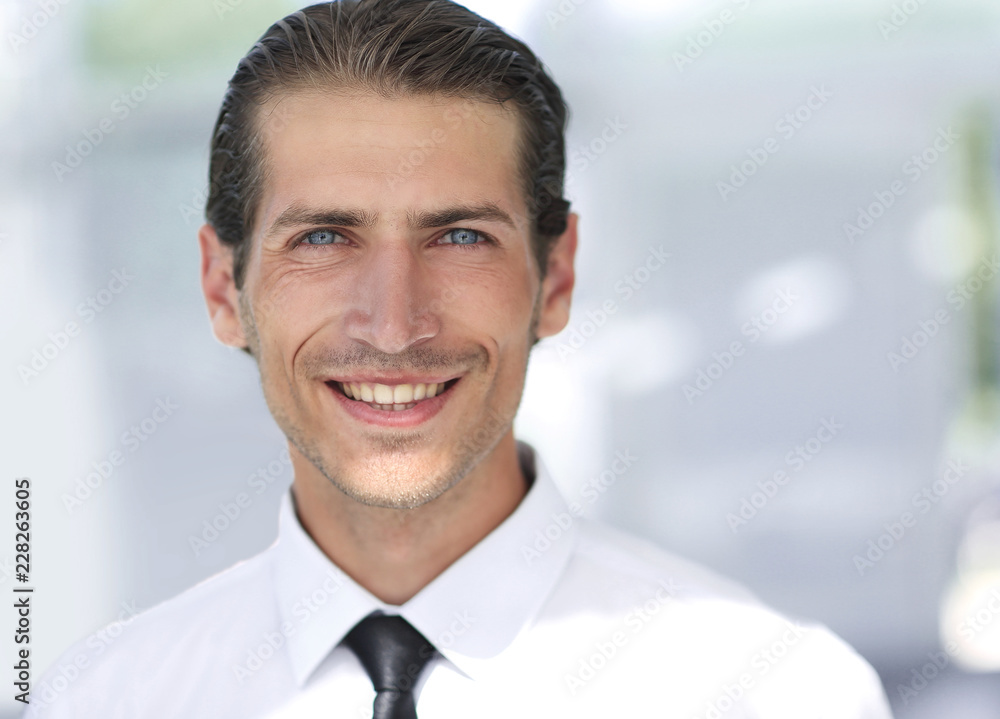 face of young businessman on background of office face of young businessman on background of office