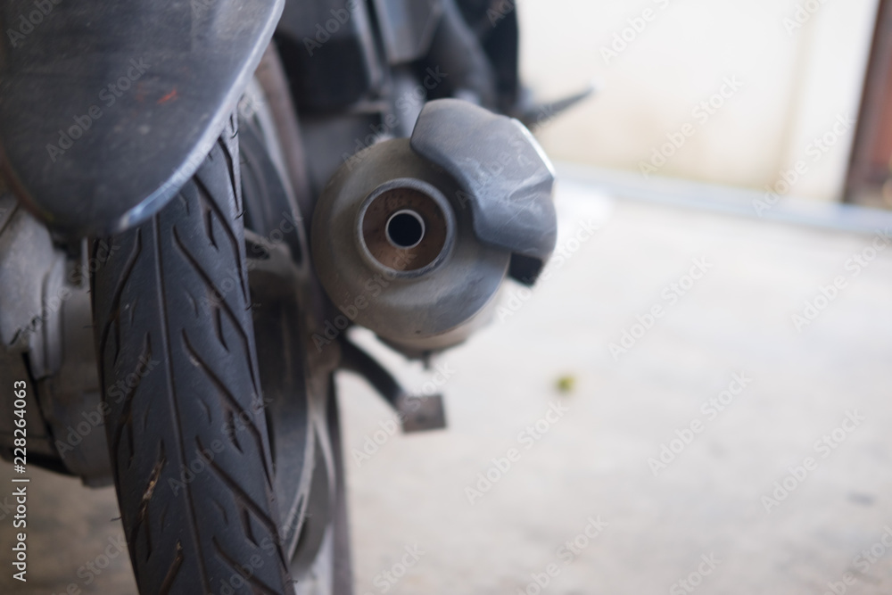 Motorcycle wheel and exhaust pipe